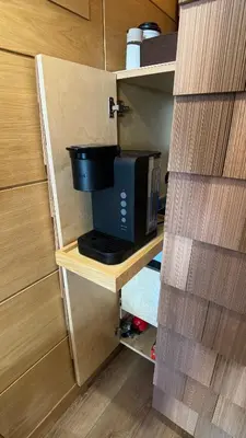 a coffee maker on a wooden shelf in a kitchen at City Hideaway, Off Grid Luxe in Lancaster