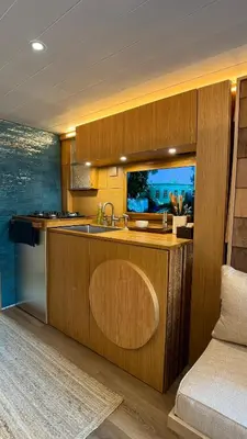 a kitchen with wooden cabinets and a sink and a couch at City Hideaway, Off Grid Luxe in Lancaster