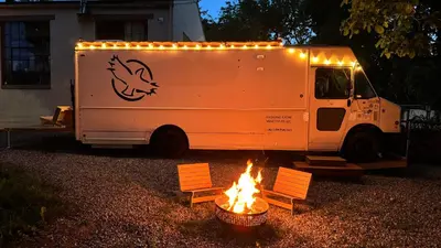 a food truck parked next to a fire pit at City Hideaway, Off Grid Luxe in Lancaster