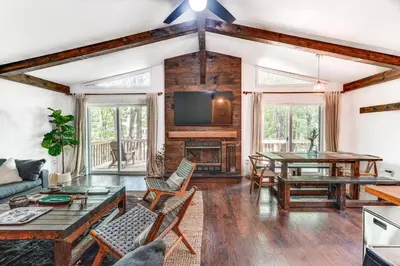 a living room with a table and chairs at Private Hot Tub Tree-Lined Poconos Home! in Pocono Summit