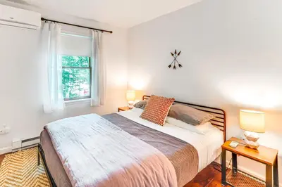 a bedroom with a large bed and a window at Private Hot Tub Tree-Lined Poconos Home! in Pocono Summit