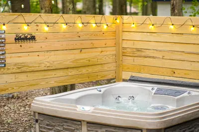 a jacuzzi tub with lights on a wooden wall at Private Hot Tub Tree-Lined Poconos Home! in Pocono Summit