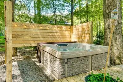 a hot tub sitting next to a wooden fence at Private Hot Tub Tree-Lined Poconos Home! in Pocono Summit