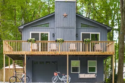 a tiny house with a deck and a star on it at Private Hot Tub Tree-Lined Poconos Home! in Pocono Summit