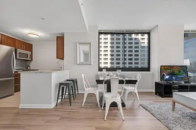 a kitchen and dining room with a table and chairs at Global Luxury Suites Downtown Jersey City in Jersey City
