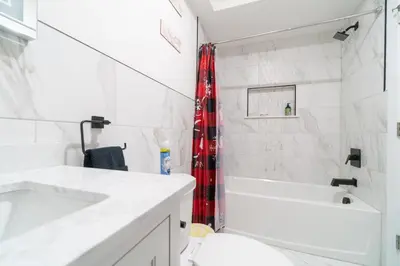 a bathroom with a tub and a sink and a shower at Divine Essence in Newark