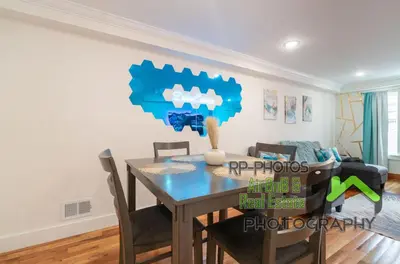 a dining room with a table and chairs at Divine Essence in Newark