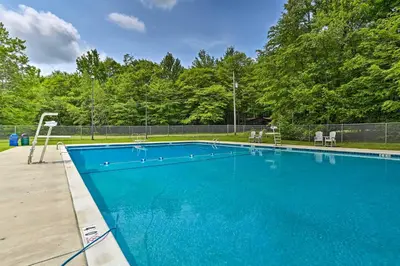 a blue swimming pool with a basketball hoop at Deck and Fire Pit Pet-Friendly Pocono Lake Abode! in Pocono Lake