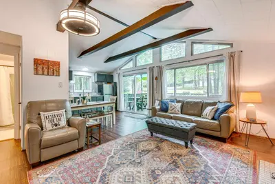 a living room with a couch and a table at Deck and Fire Pit Pet-Friendly Pocono Lake Abode! in Pocono Lake
