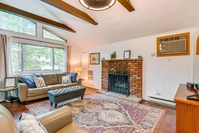 a living room with a couch and a fireplace at Deck and Fire Pit Pet-Friendly Pocono Lake Abode! in Pocono Lake