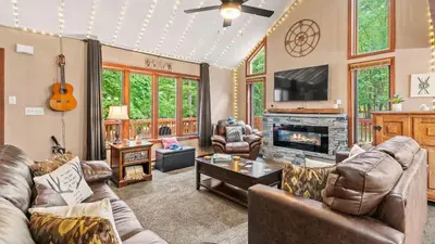 a living room with leather furniture and a fireplace at The Great Escape by AvantStay Game Room in Albrightsville