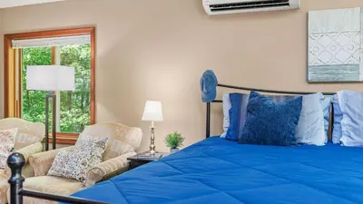 a bedroom with a blue bed and a chair at The Great Escape by AvantStay Game Room in Albrightsville