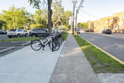 a row of bikes parked next to a street at Luxury Apt in Passaic