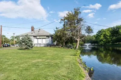 a house with a pond in front of it at Luxury Apt in Passaic