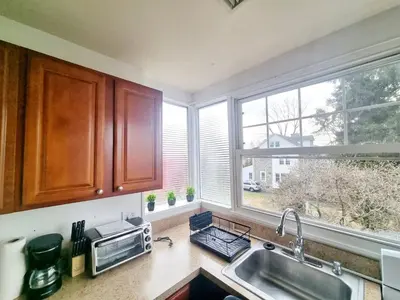 a kitchen with a sink and a window at 3BR 1BA Near Train Station Monthly Deal in Elkins Park