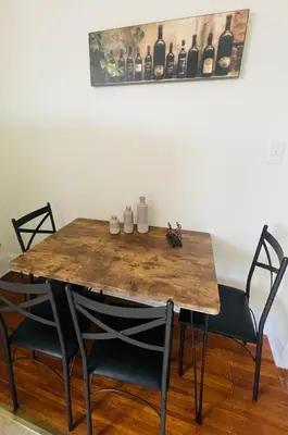 a dining room table with two chairs and a wooden table at 3BR 1BA Near Train Station Monthly Deal in Elkins Park