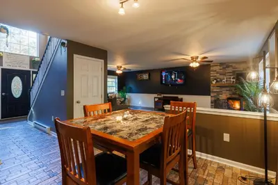 a dining room with a wooden table and chairs at Mohawk-Kudil in Poconos ! Private Pool-Hot Tub-Lake Access-Game Room in Albrightsville