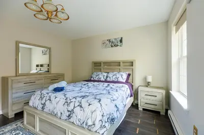 a bedroom with a bed and a dresser and a mirror at Mohawk-Kudil in Poconos ! Private Pool-Hot Tub-Lake Access-Game Room in Albrightsville