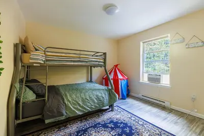 a bedroom with bunk beds and a window at Mohawk-Kudil in Poconos ! Private Pool-Hot Tub-Lake Access-Game Room in Albrightsville