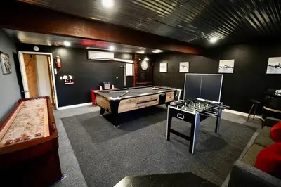 a room with a pool table and a ping pong ball at Big Blue Lake House complete with Game Room in Long Pond