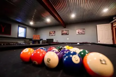 a room with a pool table with balls at Big Blue Lake House complete with Game Room in Long Pond