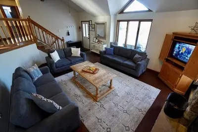 a living room with two couches and a coffee table at Big Blue Lake House complete with Game Room in Long Pond