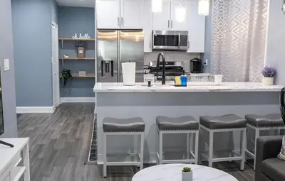 a kitchen with a counter and bar stools at New Apartment Liberty State Park Jersey City NJ Airport Train Manhattan NYC in Jersey City