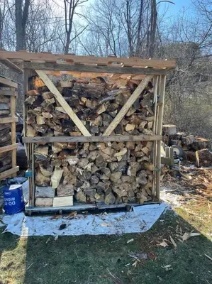 a pile of fire wood in a wooden shed at Old farmhouse with Hot tub in the Finger Lakes in Horseheads