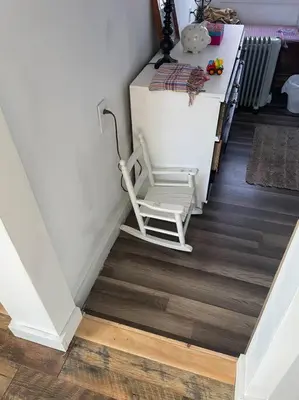 a white chair sitting on the floor in a room at Old farmhouse with Hot tub in the Finger Lakes in Horseheads