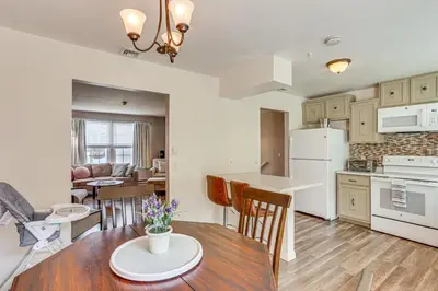 an open kitchen and living room with a table and chairs at 5 Mi to Downtown Harrisburg - Family Home! in Harrisburg