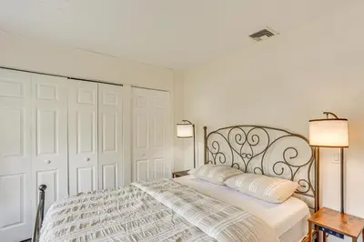 a white bedroom with a bed and two lamps at 5 Mi to Downtown Harrisburg - Family Home! in Harrisburg