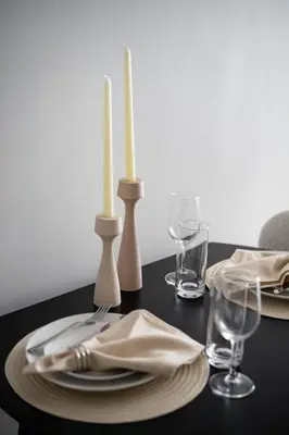 a black table with two candles and plates and glasses at Luxury Full Floor Chelsea Apt St 7 in New York