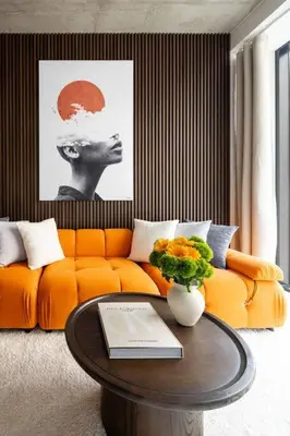 a living room with a orange couch and a table at Luxury Full Floor Chelsea Apt St 7 in New York