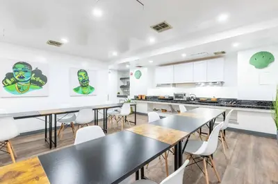 a kitchen with tables and chairs in a room at Mansfield in New York