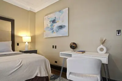 a bedroom with a bed and a desk with a chair at Mansfield in New York