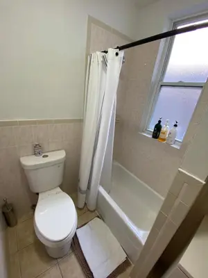a bathroom with a toilet and a shower and a window at Apart Studio West NY 12Mints From NYCity Times Square in West New York