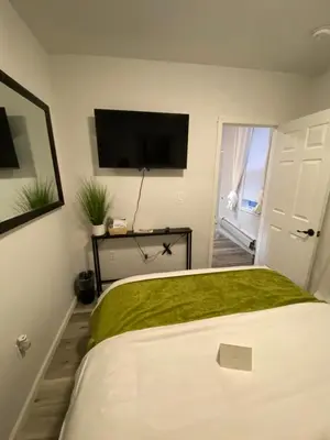 a bedroom with a bed and a flat screen tv at Apart Studio West NY 12Mints From NYCity Times Square in West New York