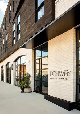 a building with a sign on the side of it at Archway Hotel Residence in Philadelphia