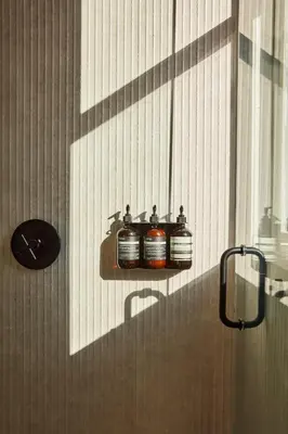 a bathroom with three jars on a wall at Archway Hotel Residence in Philadelphia