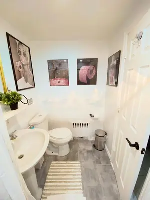 a bathroom with a white toilet and a sink at Private Room A-KING BED-12Mints NYCity Times Square in West New York