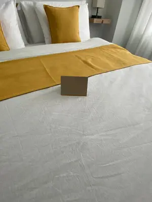 a bed with a yellow blanket on top of it at Private Room A-KING BED-12Mints NYCity Times Square in West New York