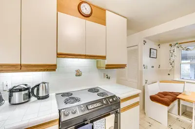 a kitchen with white cabinets and a stove top oven at Movie Room and Home Gym Sinking Spring Home! in Sinking Spring