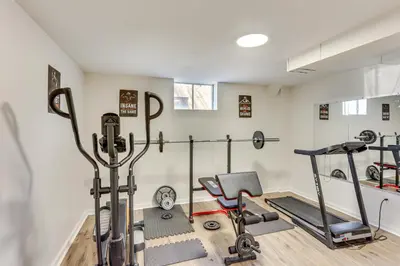 a fitness room with a treadmill and a gym at Movie Room and Home Gym Sinking Spring Home! in Sinking Spring