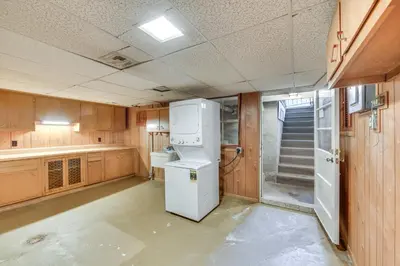 a kitchen with a white refrigerator and a staircase at Movie Room and Home Gym Sinking Spring Home! in Sinking Spring