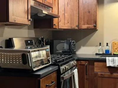 a kitchen with a toaster oven and a microwave at Private Cottage with Hot Tub in the Woods in Thompson