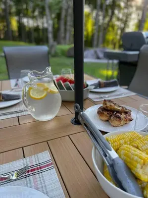 a table with a plate of food and a bowl of corn at Private Cottage with Hot Tub in the Woods in Thompson
