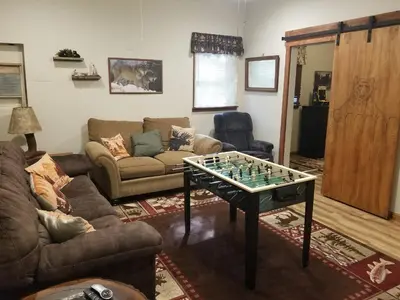 a living room with a chess board on a table at Serenity and Fun all in one in this Cozy Pocono Cabin in Jim Thorpe