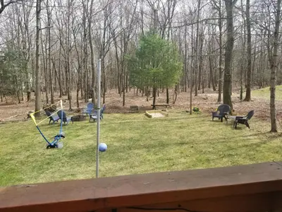 a view of a park with benches and a playground at Serenity and Fun all in one in this Cozy Pocono Cabin in Jim Thorpe