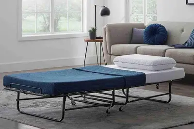 a bed on a metal frame in a living room at 2 Days Stay Get 40 percent OFF for, Sleeps 6 & 2 Queen in Newark