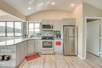 a kitchen with white cabinets and stainless steel appliances at Modern Harveys Lake Apartment with Beach Access! in Harveys Lake